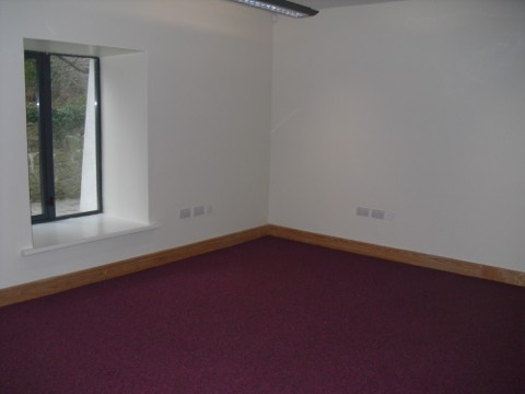 Suite Two: a bright empty office with a deep granite window reveal